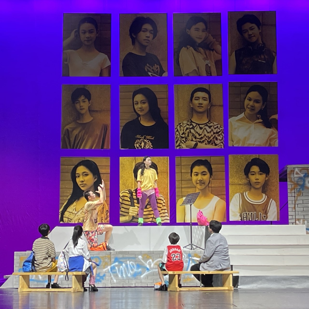 On stage under purple light during the Showcase production