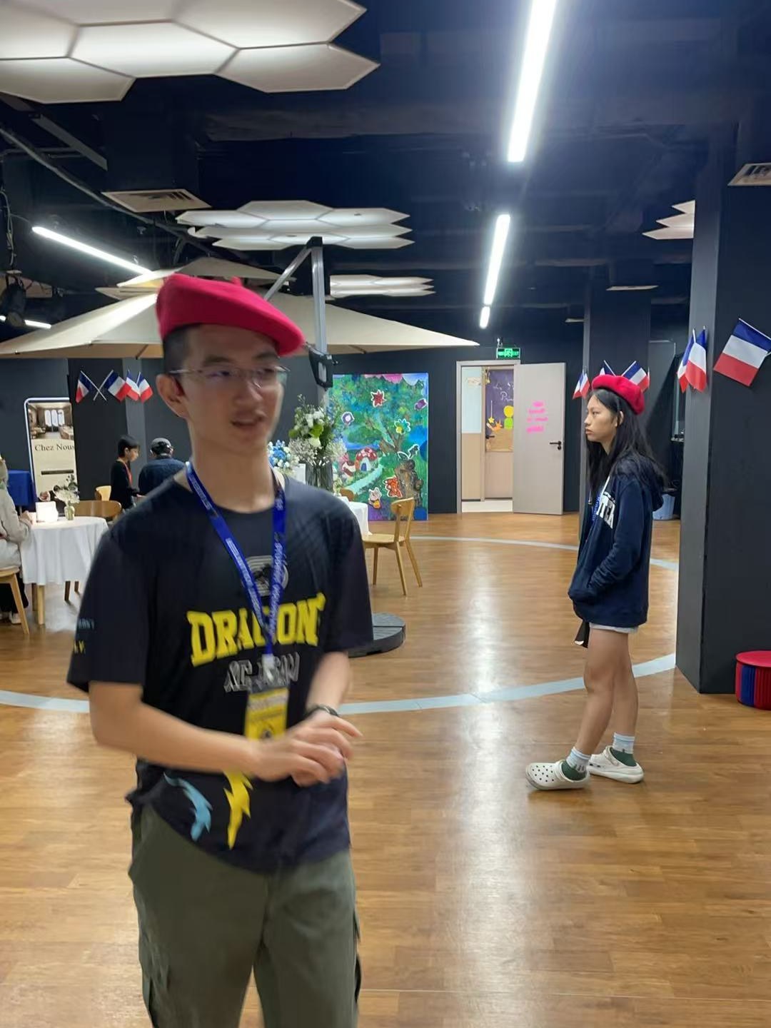 Chris at a community volunteering event, wearing a red beret and event lanyard